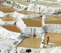 After the pans are filled with the hypersaline water of a nearby warm spring, the dry Andean air evaporates the water and leaves the precious pink Maras salt which is hand-harvested; photo: dachalan