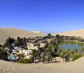 Huacachina, with a permanent population of only about 120, was built around a picture-postcard natural desert lake amid up to 200 m high sand dunes and today is the destination in Peru for dune buggying and sand boarding.