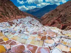 The Salt Ponds of Maras are located 50 km (about 30 miles) north-west of Cusco and about 16 km (10 miles) on road from Urubamba along the slopes of the Qaqawiñay mountain at an elevation of over 3,000 m (over 10,000 ft).