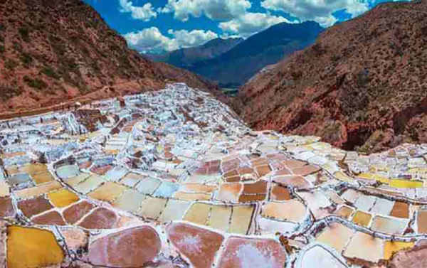 The Salt Ponds of Maras are located 50 km (about 30 miles) north-west of Cusco and about 16 km (10 miles) on road from Urubamba along the slopes of the Qaqawiñay mountain at an elevation of over 3,000 m (over 10,000 ft).